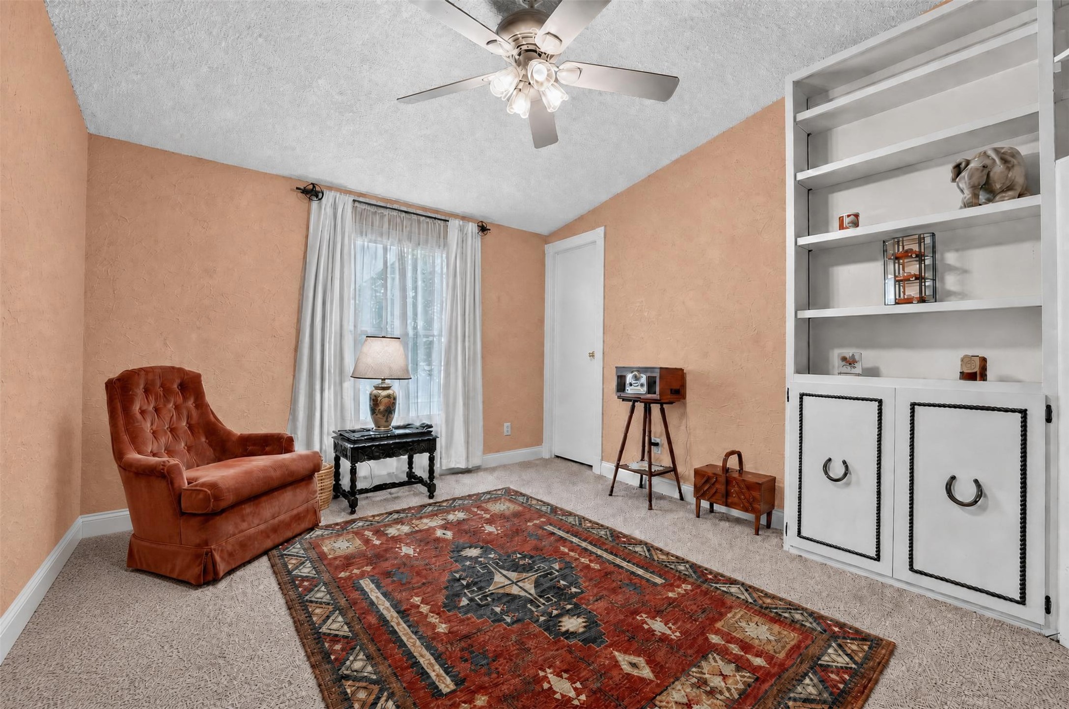 317 Rae Lane Jarrell, TX 76537 - Photo 38 of 40 A cozy retreat features a vaulted ceiling, soft carpeted flooring, and built-in shelving for storage.
