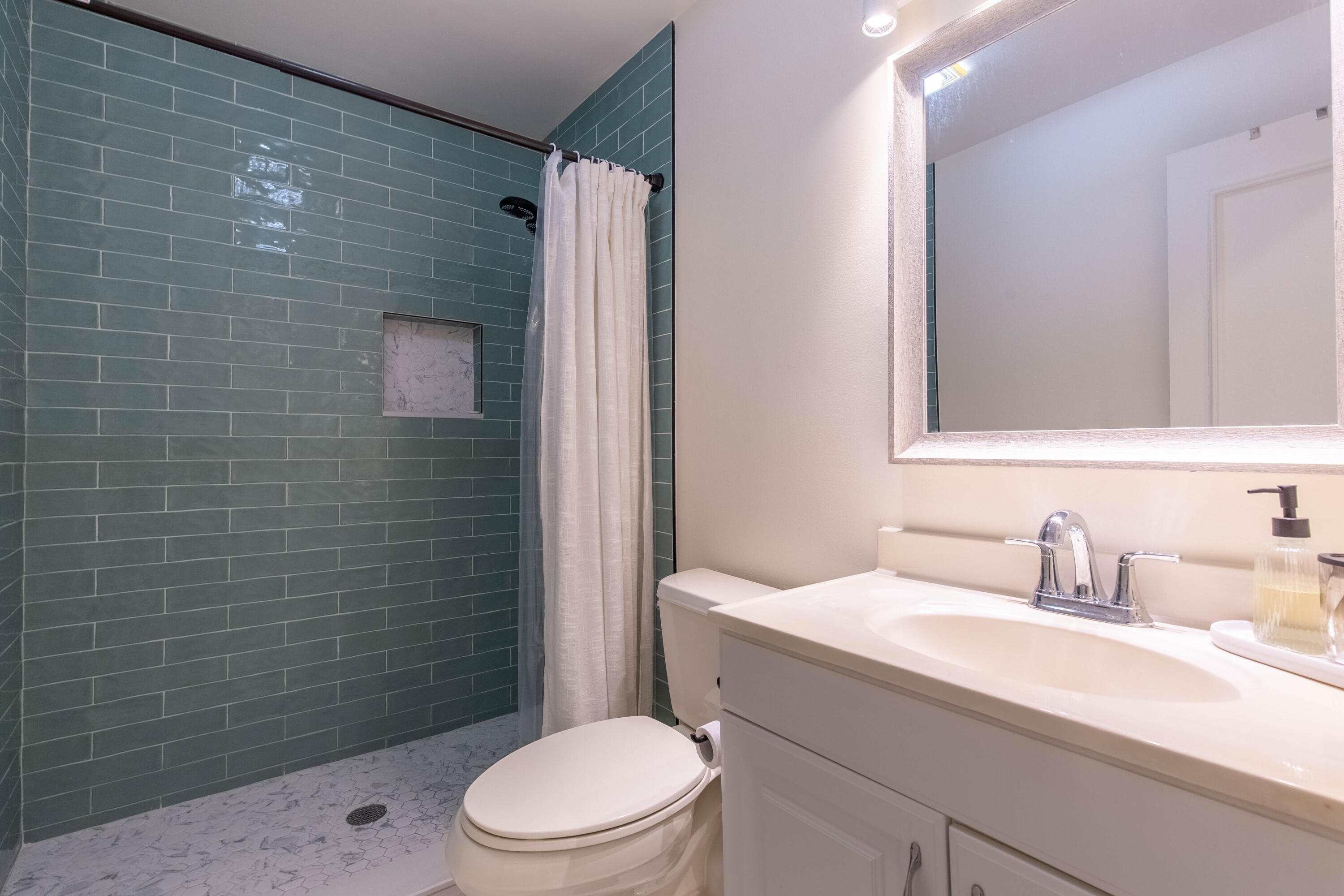 13165 Chadwick Court, Unit 32 Wellington, FL 33414 - Photo 15 of 25 a bathroom with a sink a toilet and shower