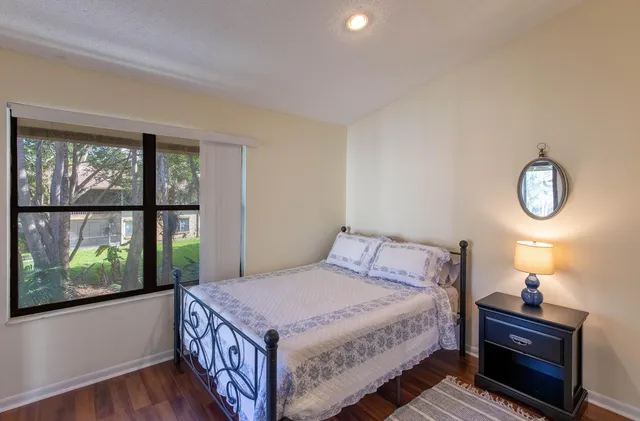 a bedroom with a bed and a window