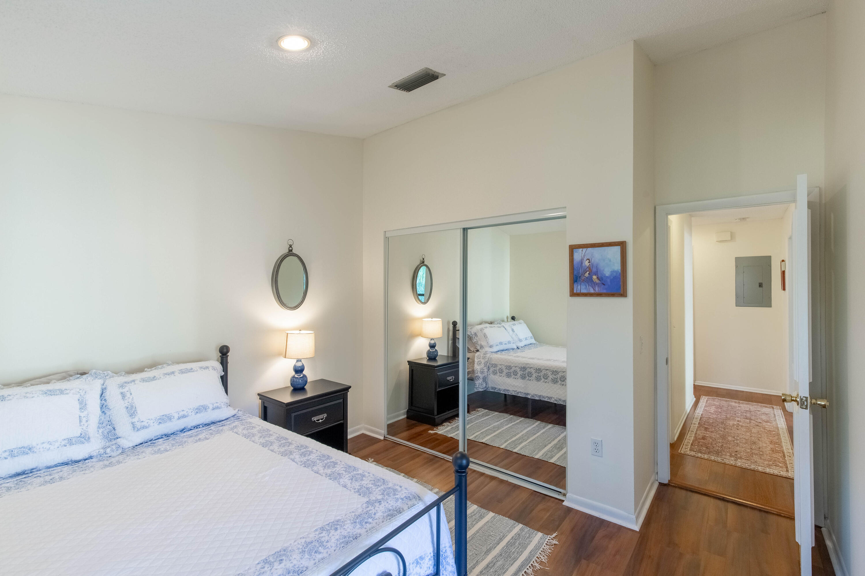 13165 Chadwick Court, Unit 32 Wellington, FL 33414 - Photo 18 of 25 a bedroom with furniture and a wooden floor