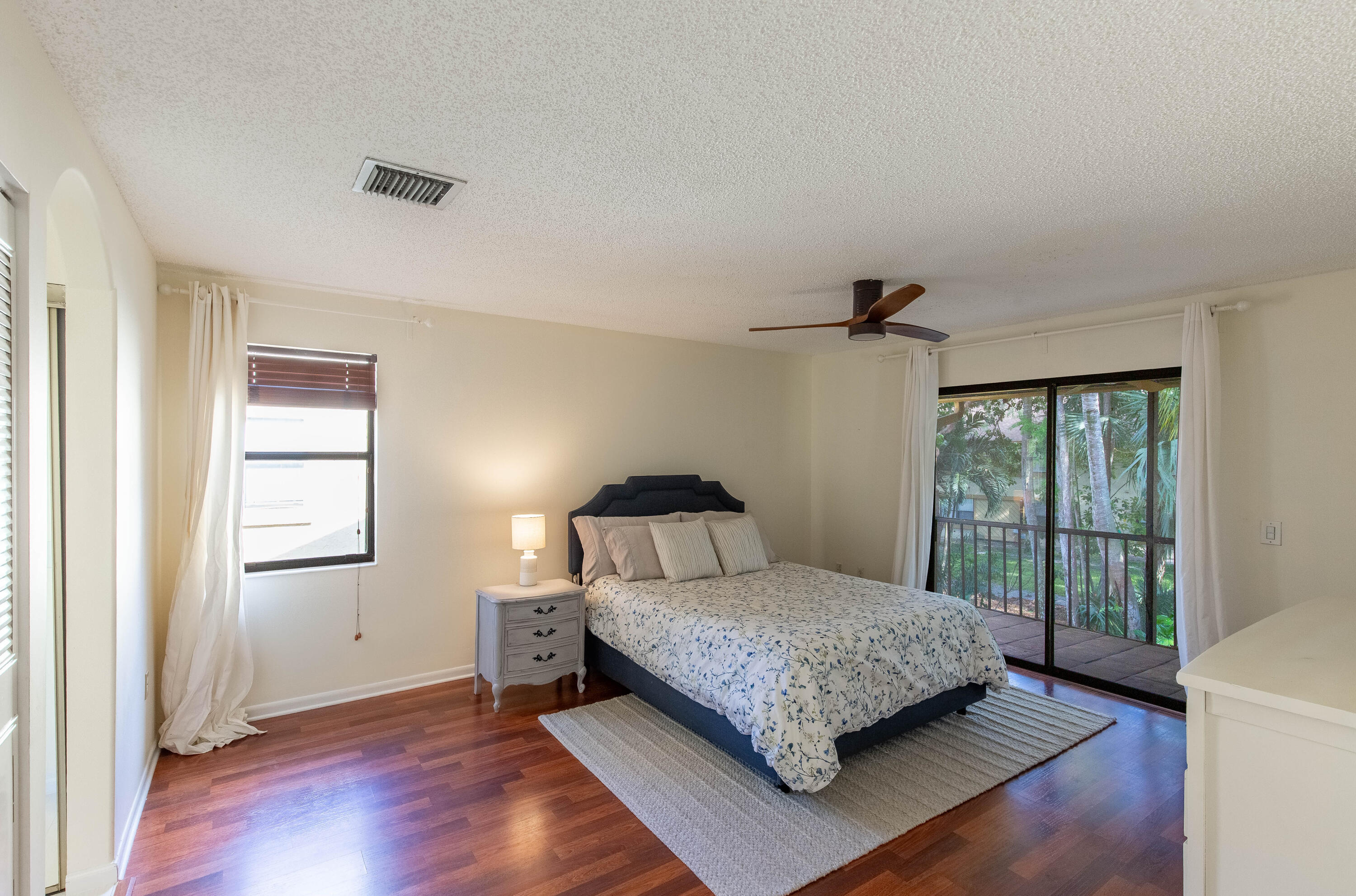 13165 Chadwick Court, Unit 32 Wellington, FL 33414 - Photo 19 of 25 a bedroom with a bed table and window