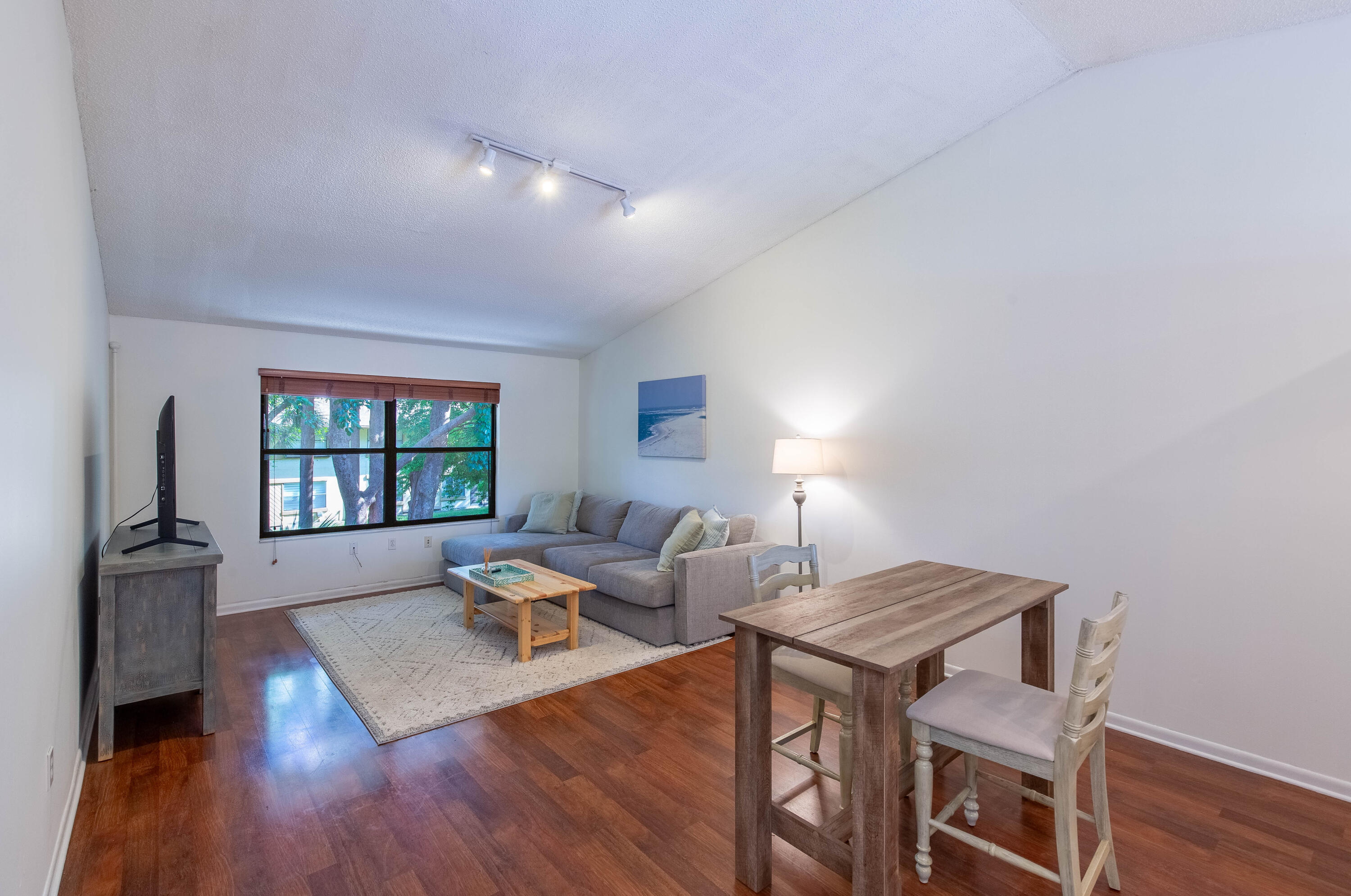 13165 Chadwick Court, Unit 32 Wellington, FL 33414 - Photo 2 of 25 a living room with furniture and wooden floor