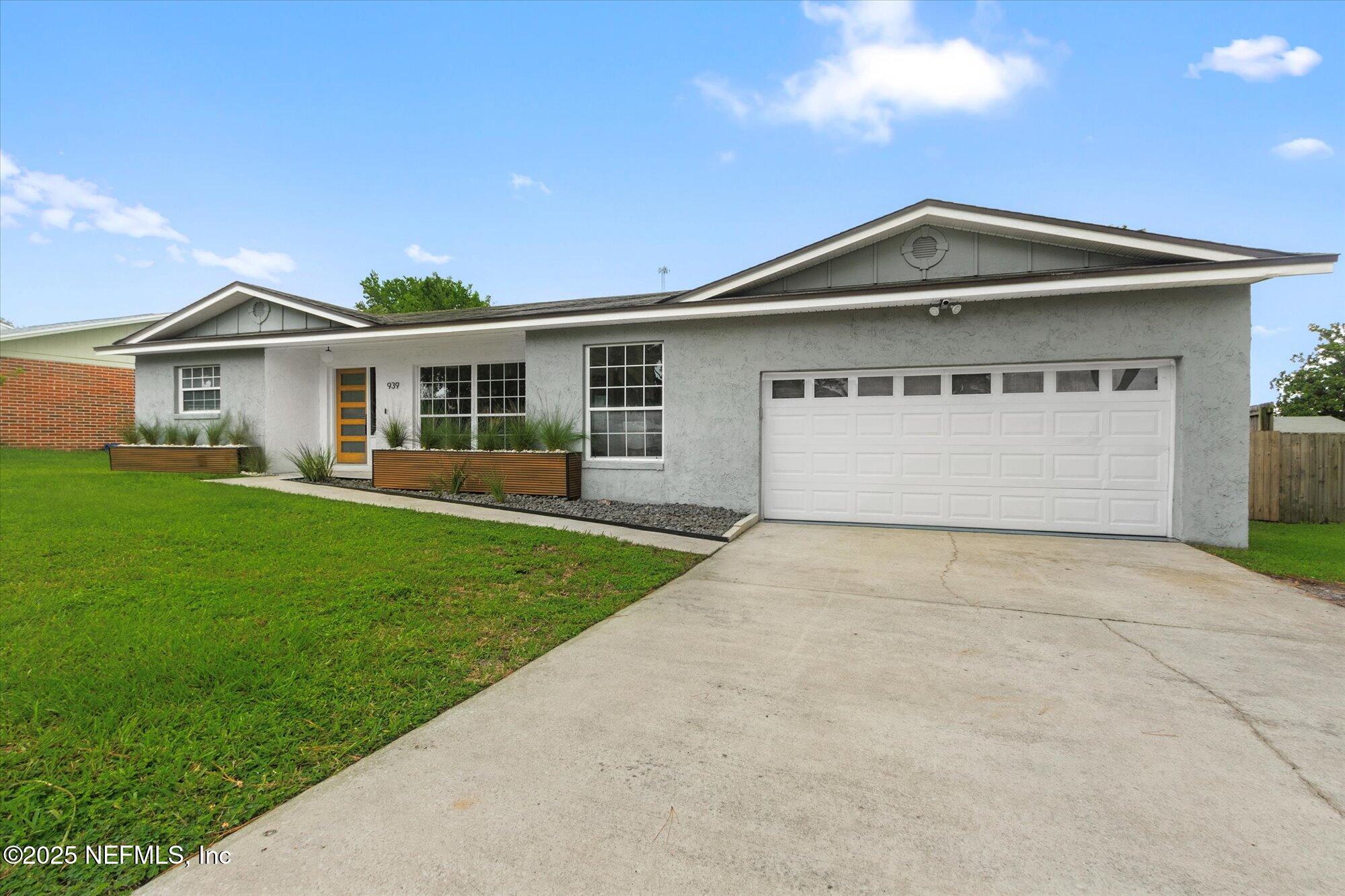 939 Grove Park Drive North Orange Park, FL 32073 - Photo 14 of 57 a front view of a house with a yard