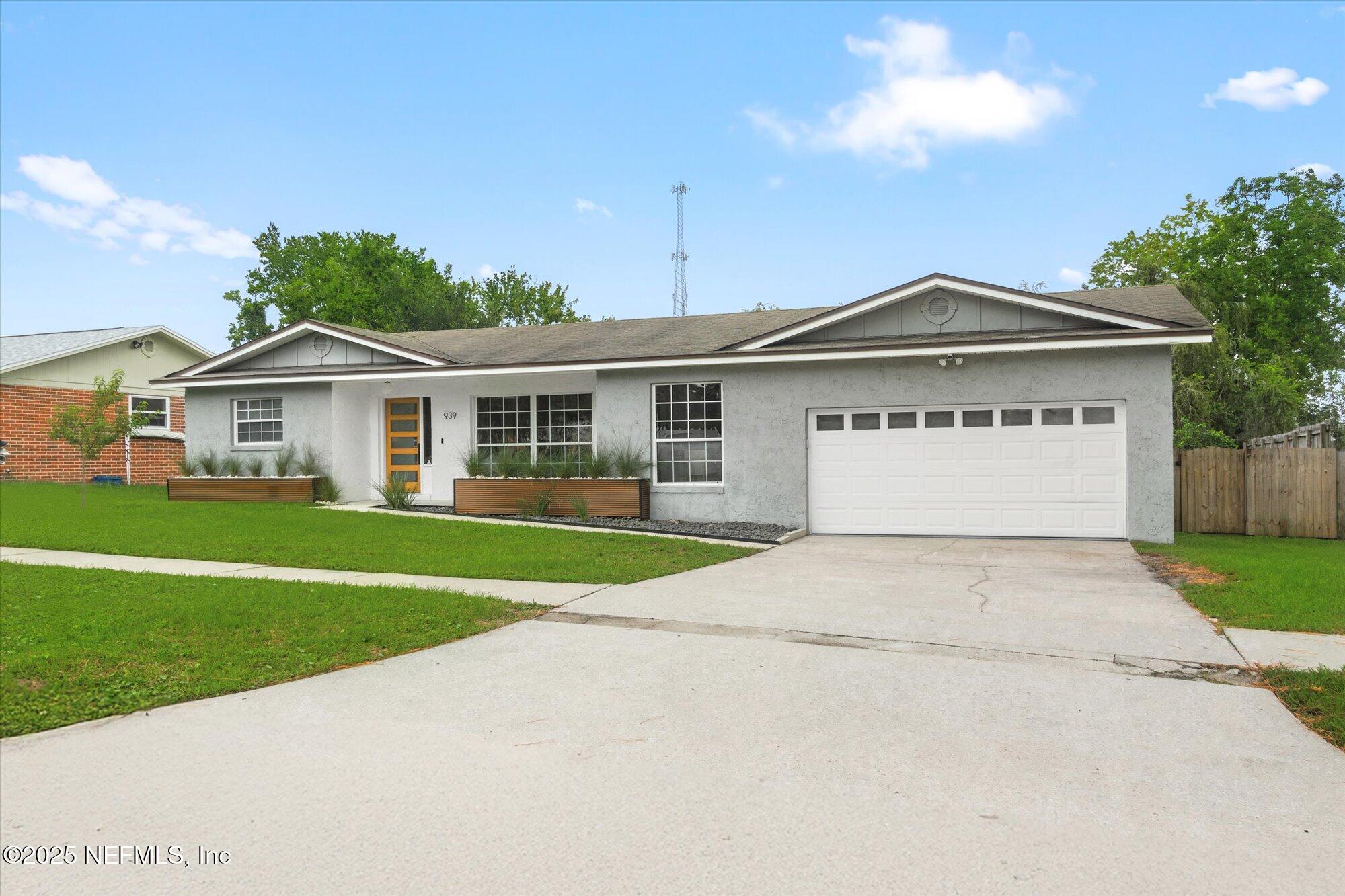 939 Grove Park Drive North Orange Park, FL 32073 - Photo 15 of 57 a front view of a house with a garden