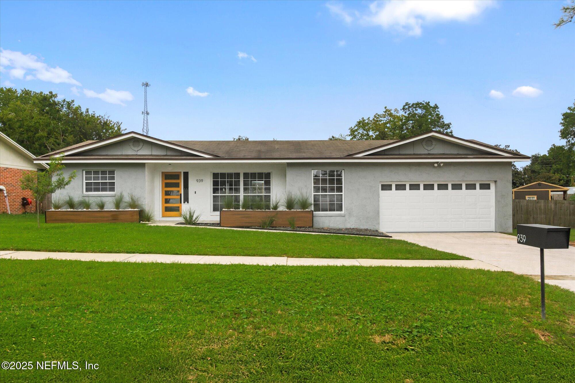 939 Grove Park Drive North Orange Park, FL 32073 - Photo 16 of 57 a front view of a house with a garden