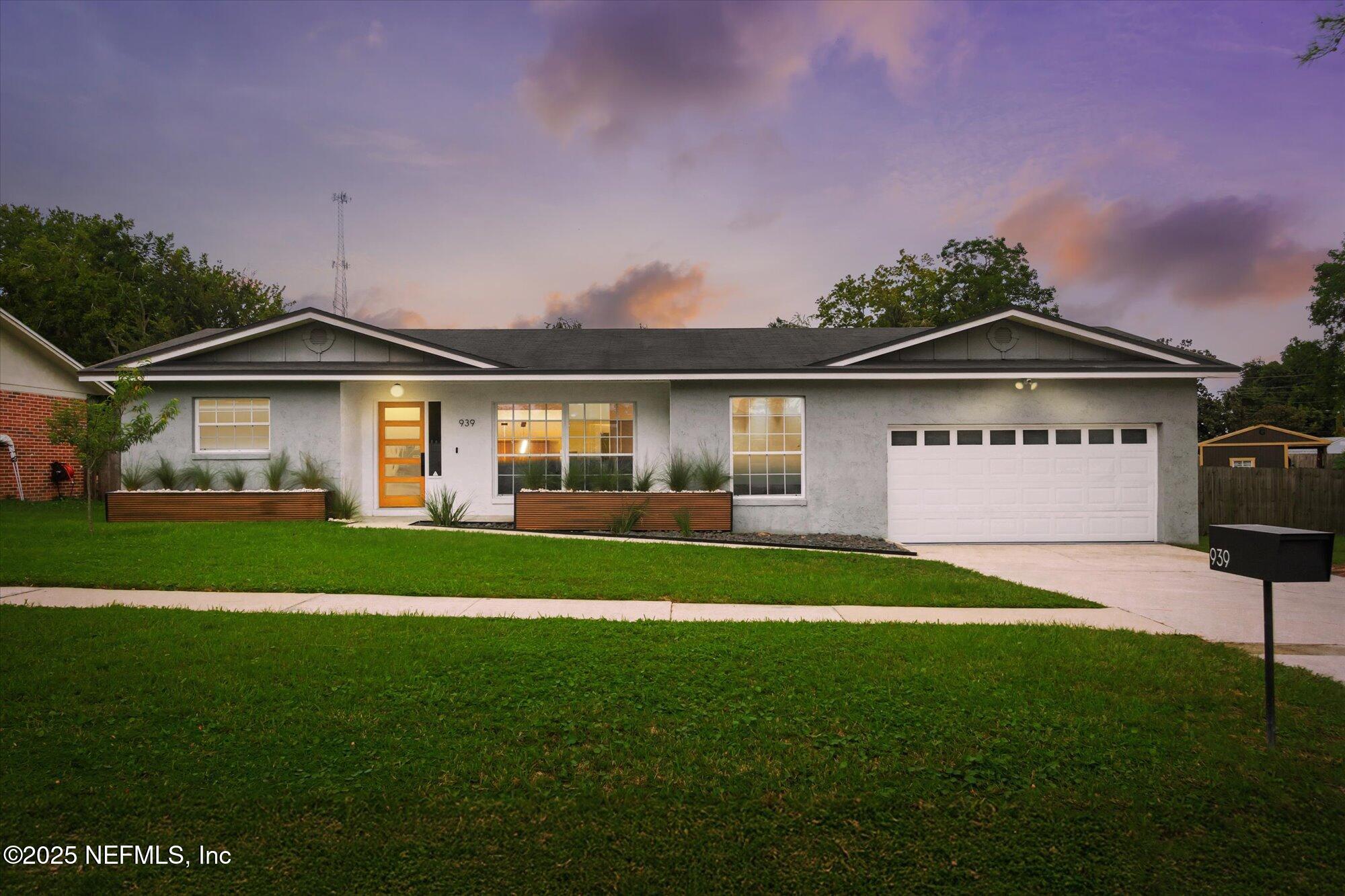 939 Grove Park Drive North Orange Park, FL 32073 - Photo 17 of 57 a front view of a house with a garden and yard