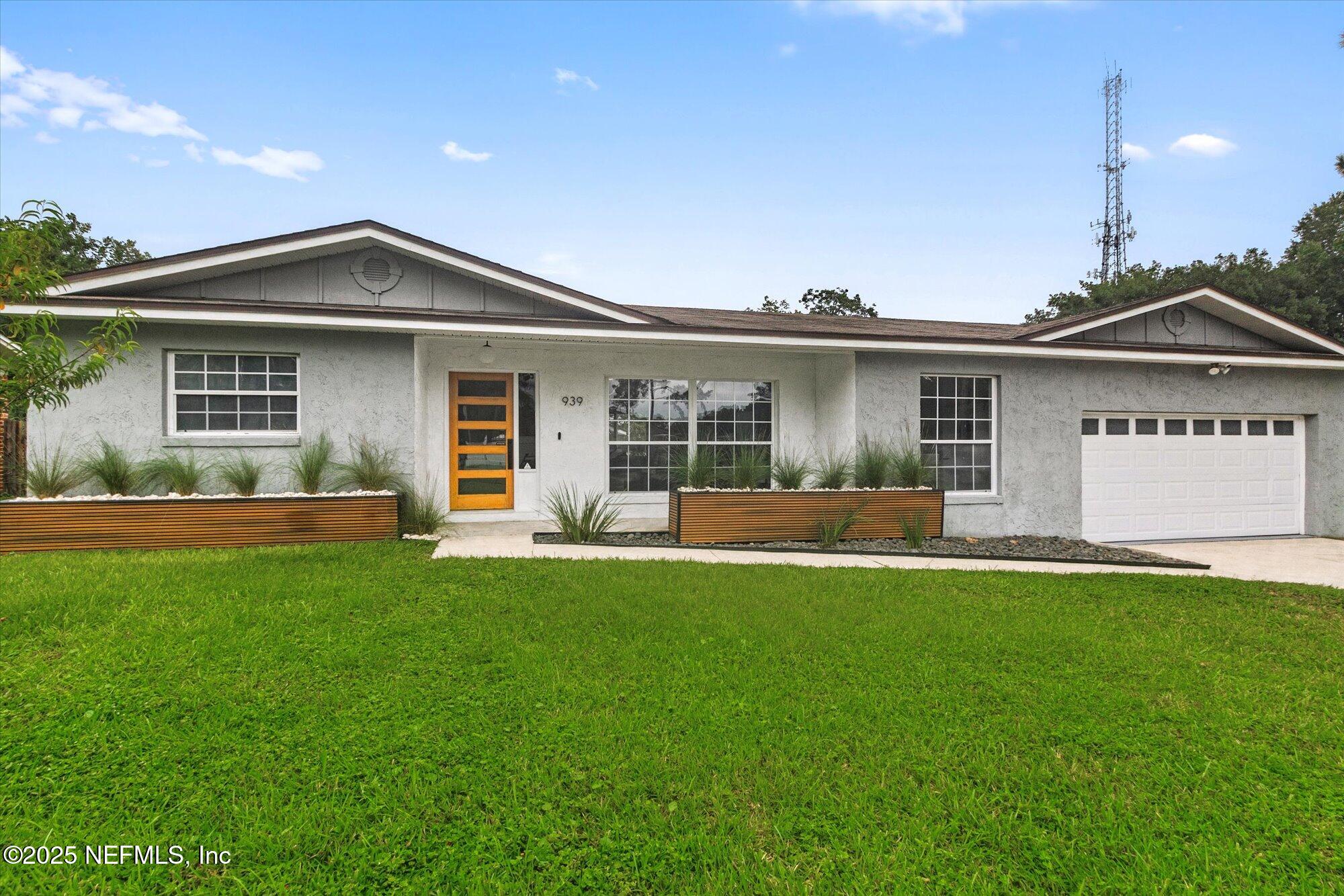 939 Grove Park Drive North Orange Park, FL 32073 - Photo 18 of 57 a front view of a house with a garden and yard