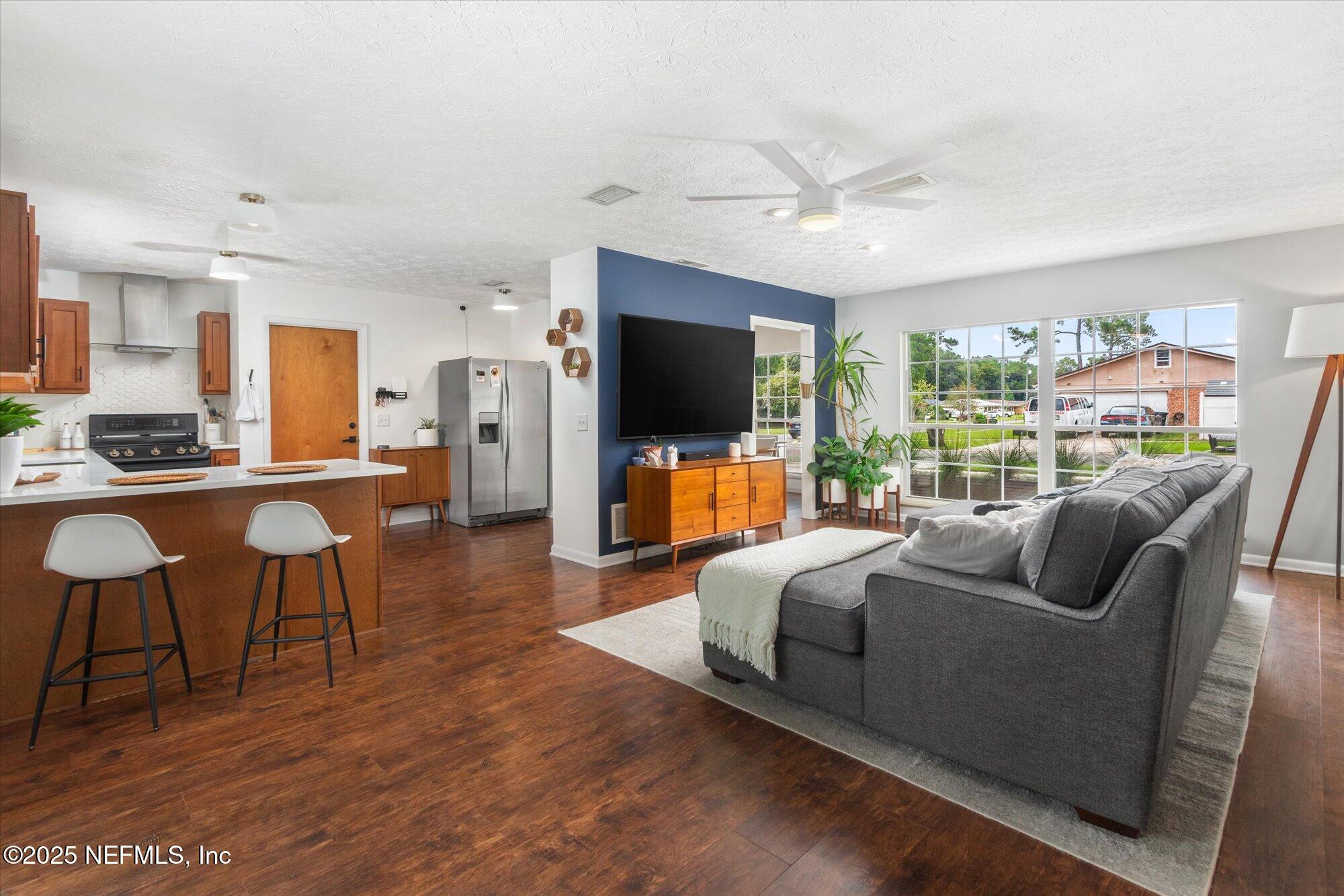 939 Grove Park Drive North Orange Park, FL 32073 - Photo 19 of 57 a living room with furniture and a flat screen tv