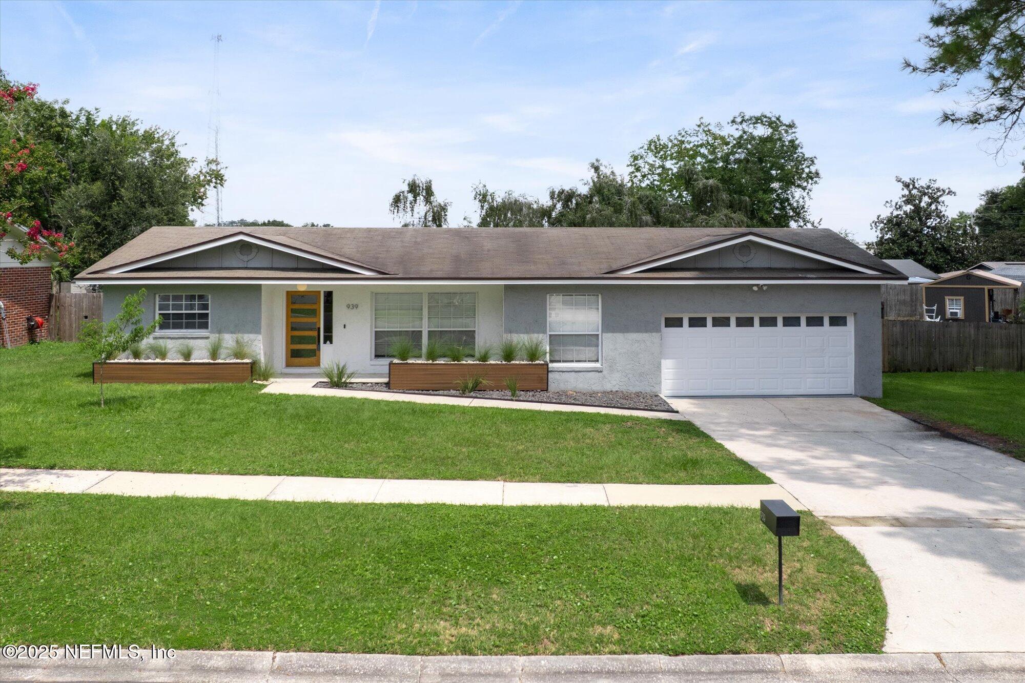 939 Grove Park Drive North Orange Park, FL 32073 - Photo 2 of 57 a front view of a house with a yard