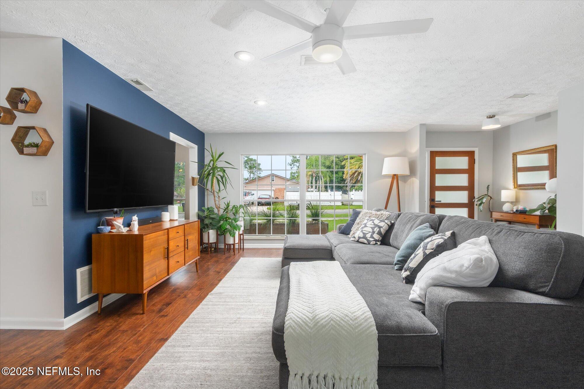 939 Grove Park Drive North Orange Park, FL 32073 - Photo 22 of 57 a living room with furniture and a flat screen tv