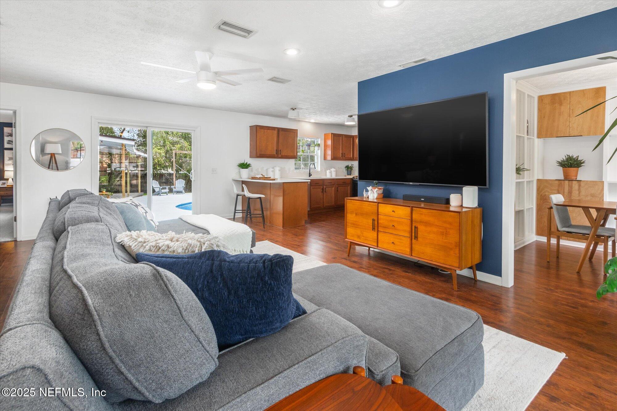 939 Grove Park Drive North Orange Park, FL 32073 - Photo 23 of 57 a living room with furniture and a flat screen tv