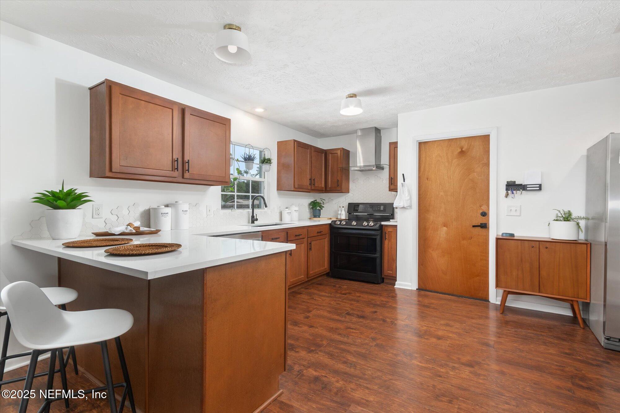 939 Grove Park Drive North Orange Park, FL 32073 - Photo 25 of 57 a kitchen with stainless steel appliances granite countertop a sink stove and refrigerator