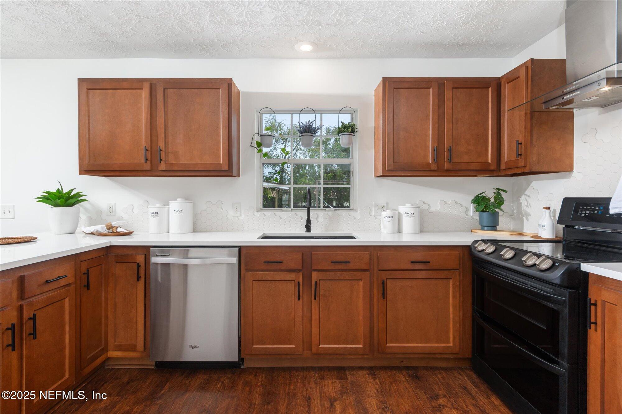 939 Grove Park Drive North Orange Park, FL 32073 - Photo 26 of 57 a kitchen with a sink stove and cabinets