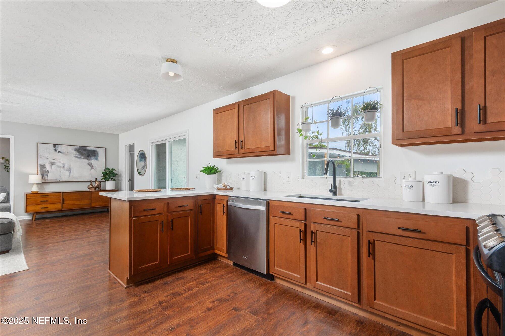939 Grove Park Drive North Orange Park, FL 32073 - Photo 27 of 57 a kitchen with stainless steel appliances granite countertop a sink and wooden cabinets