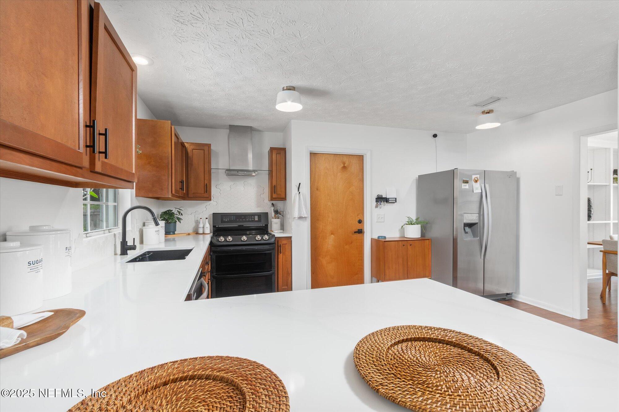 939 Grove Park Drive North Orange Park, FL 32073 - Photo 29 of 57 a kitchen with stainless steel appliances granite countertop a sink dishwasher and refrigerator with wooden floor
