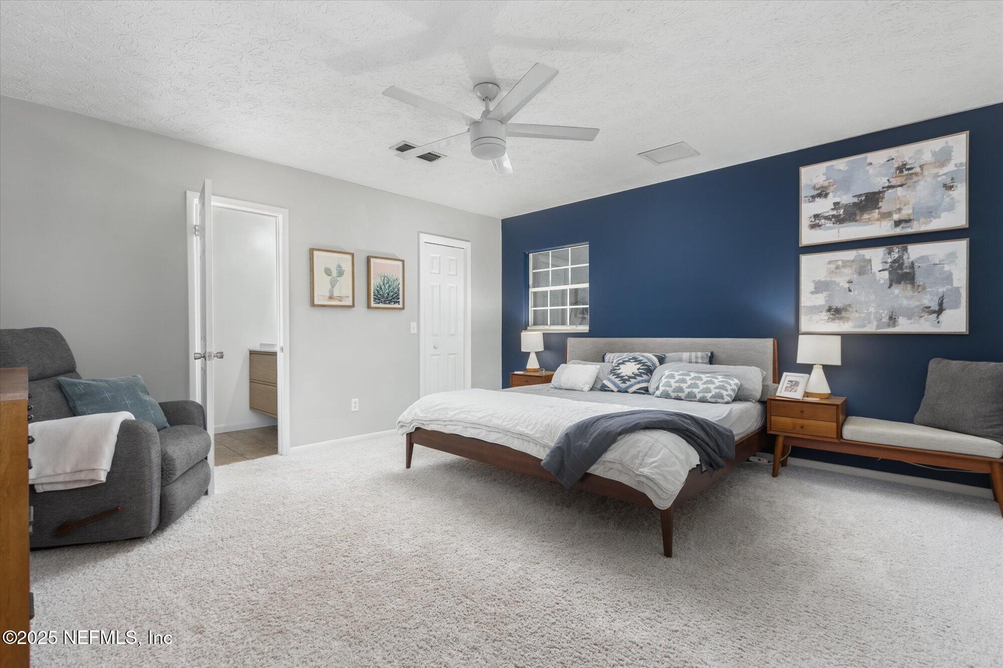 939 Grove Park Drive North Orange Park, FL 32073 - Photo 37 of 57 a bed room with a bed and a couch