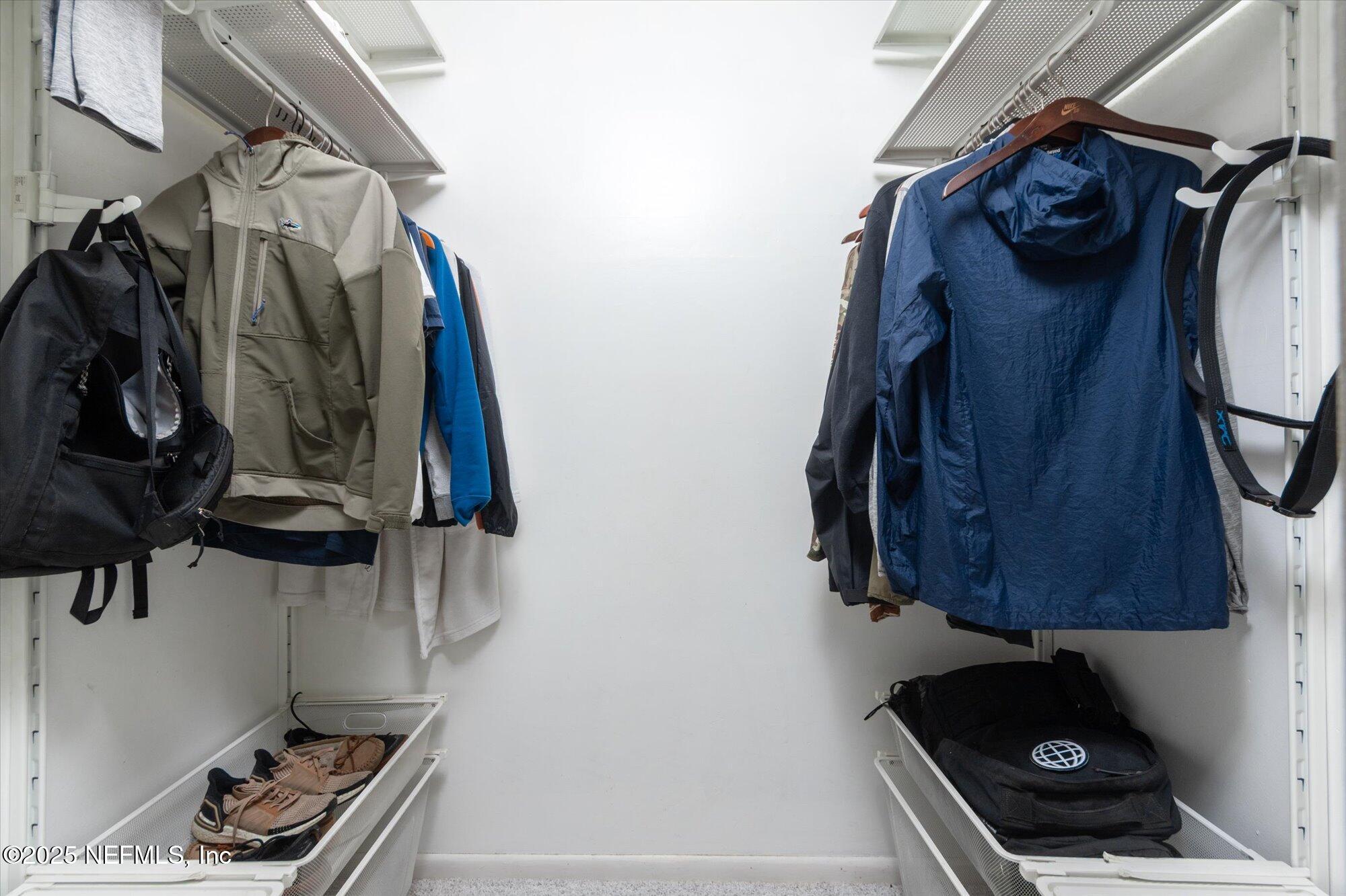 939 Grove Park Drive North Orange Park, FL 32073 - Photo 42 of 57 a view of walk in closet with clothes and shoes