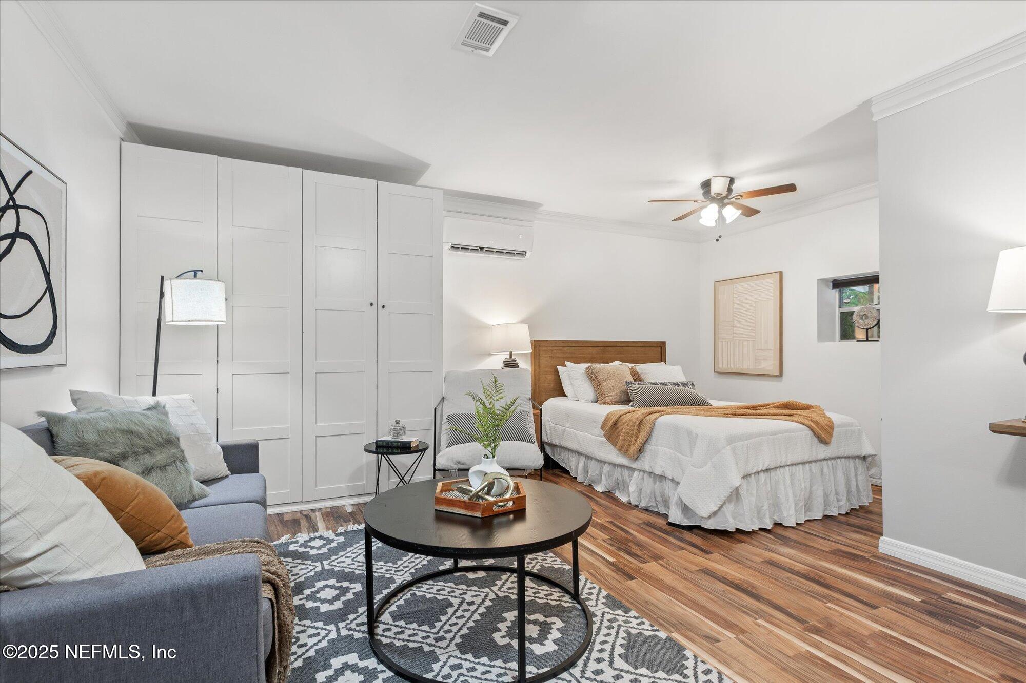 939 Grove Park Drive North Orange Park, FL 32073 - Photo 44 of 57 a spacious bedroom with a bed and wooden floor