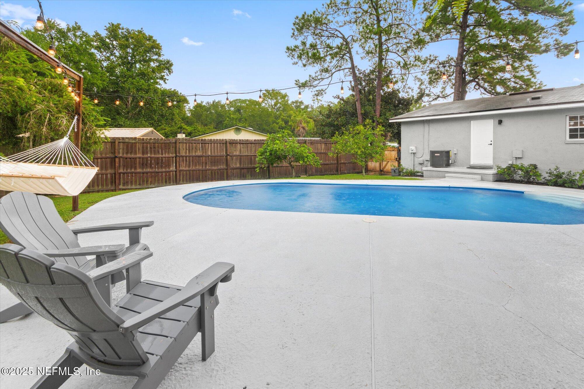 939 Grove Park Drive North Orange Park, FL 32073 - Photo 50 of 57 a view of a chairs and table in the backyard