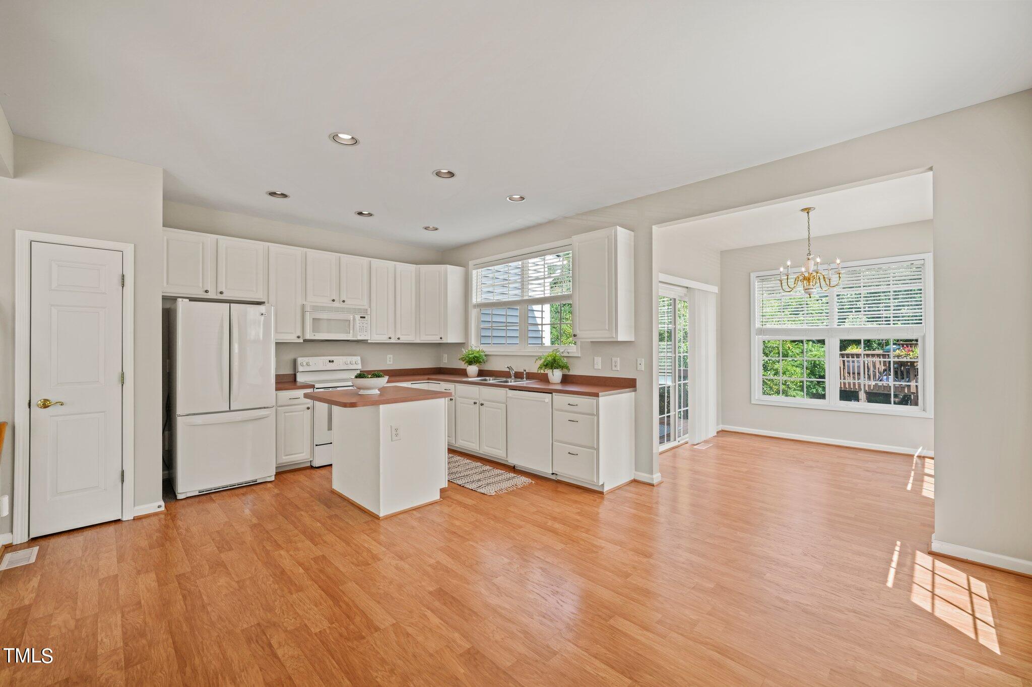 5325 Echo Ridge Road Raleigh, NC 27612 - Photo 12 of 61 a kitchen with a refrigerator and white cabinets
