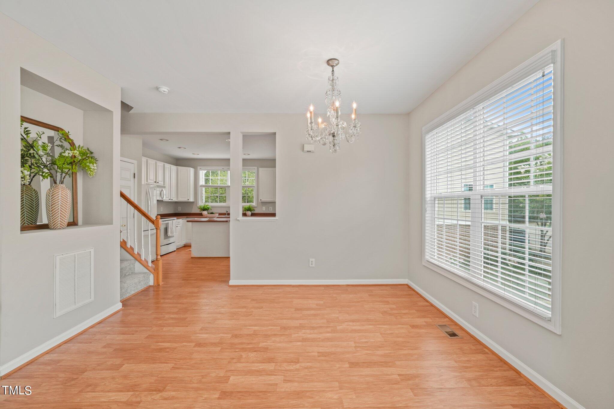 5325 Echo Ridge Road Raleigh, NC 27612 - Photo 25 of 61 a view of an empty room with wooden floor and a window