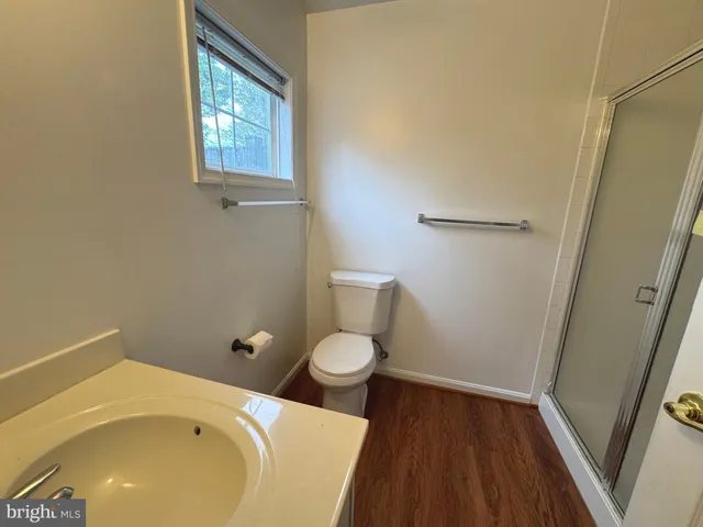 a bathroom with a granite countertop toilet and a sink