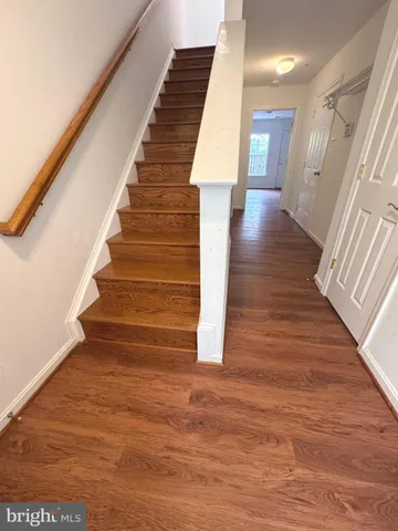 a view of entryway and hall with wooden floor