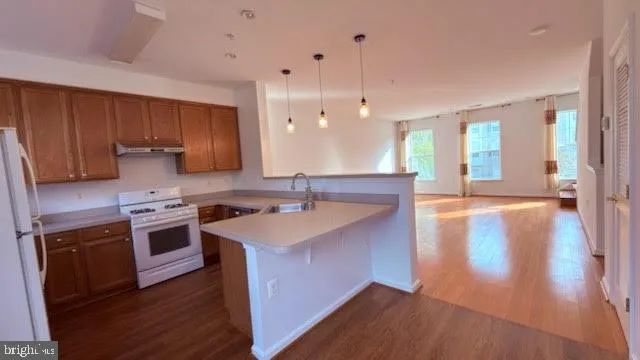 a kitchen with a sink and a stove top oven