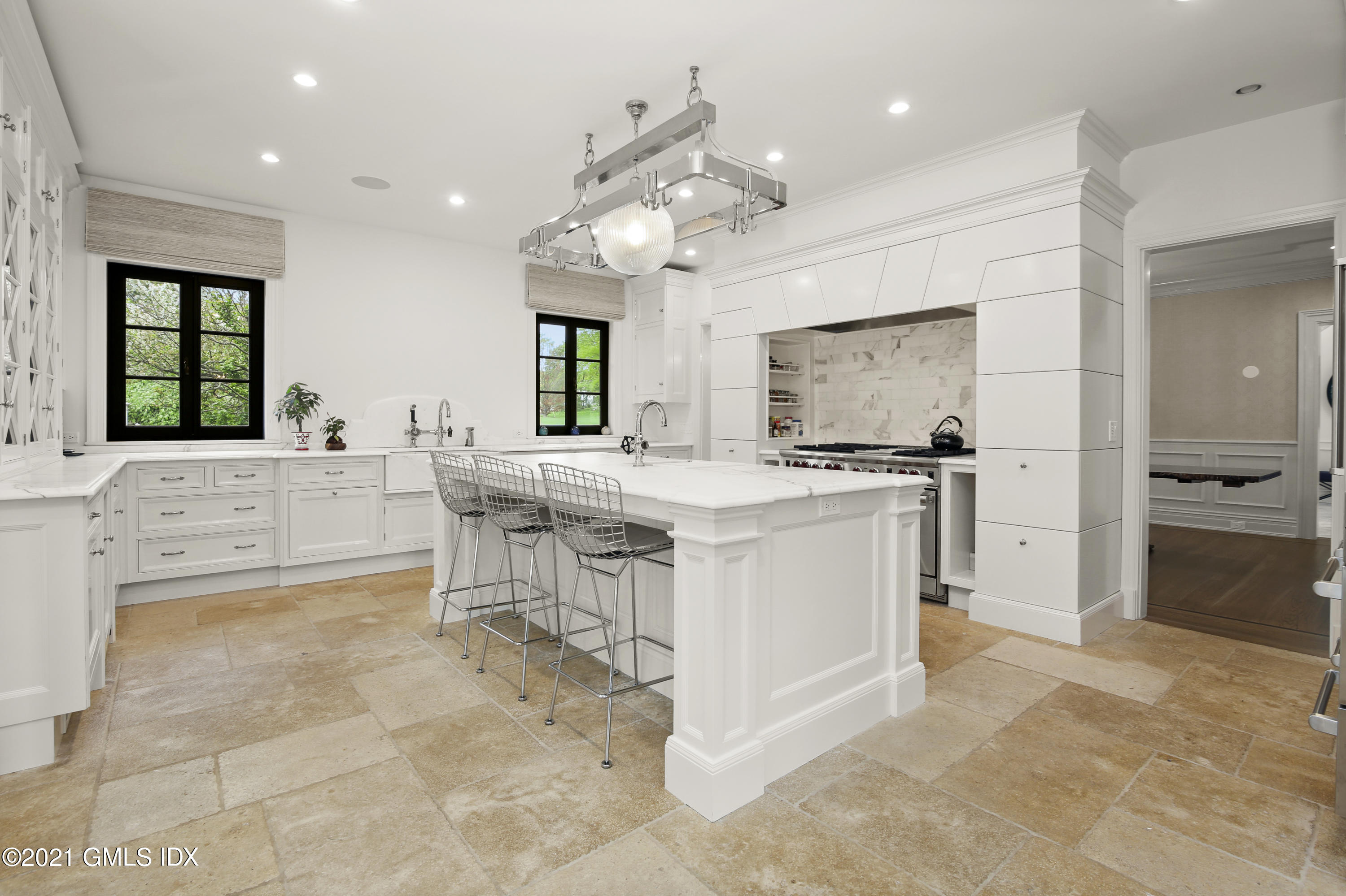 200 Stanwich Road Greenwich, CT 06830 - Photo 29 of 80 a large kitchen with kitchen island a stove a sink a dining table and chairs