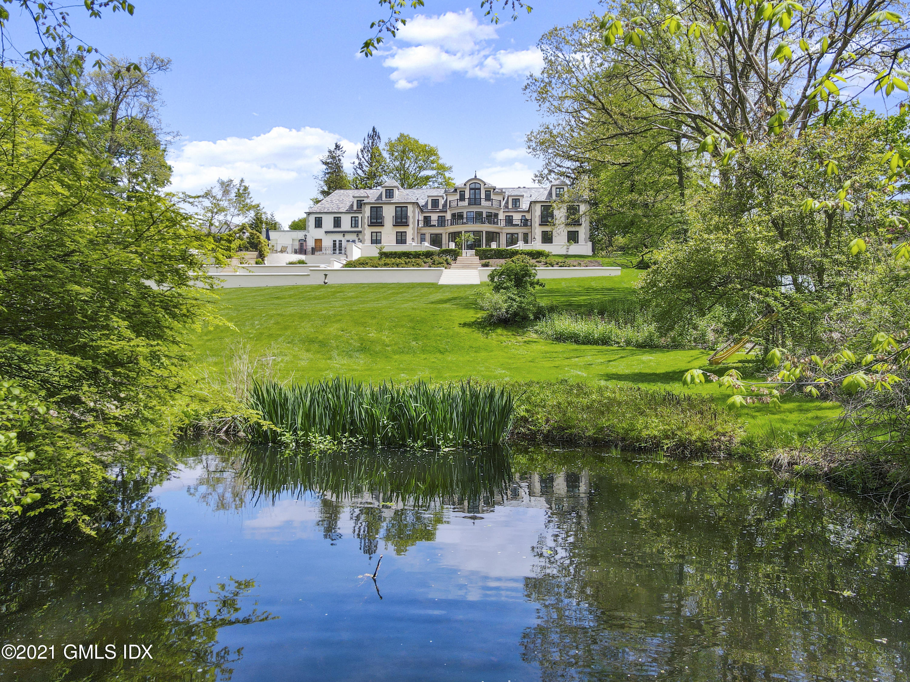 200 Stanwich Road Greenwich, CT 06830 - Photo 3 of 80 a view of a house with a yard and a pond