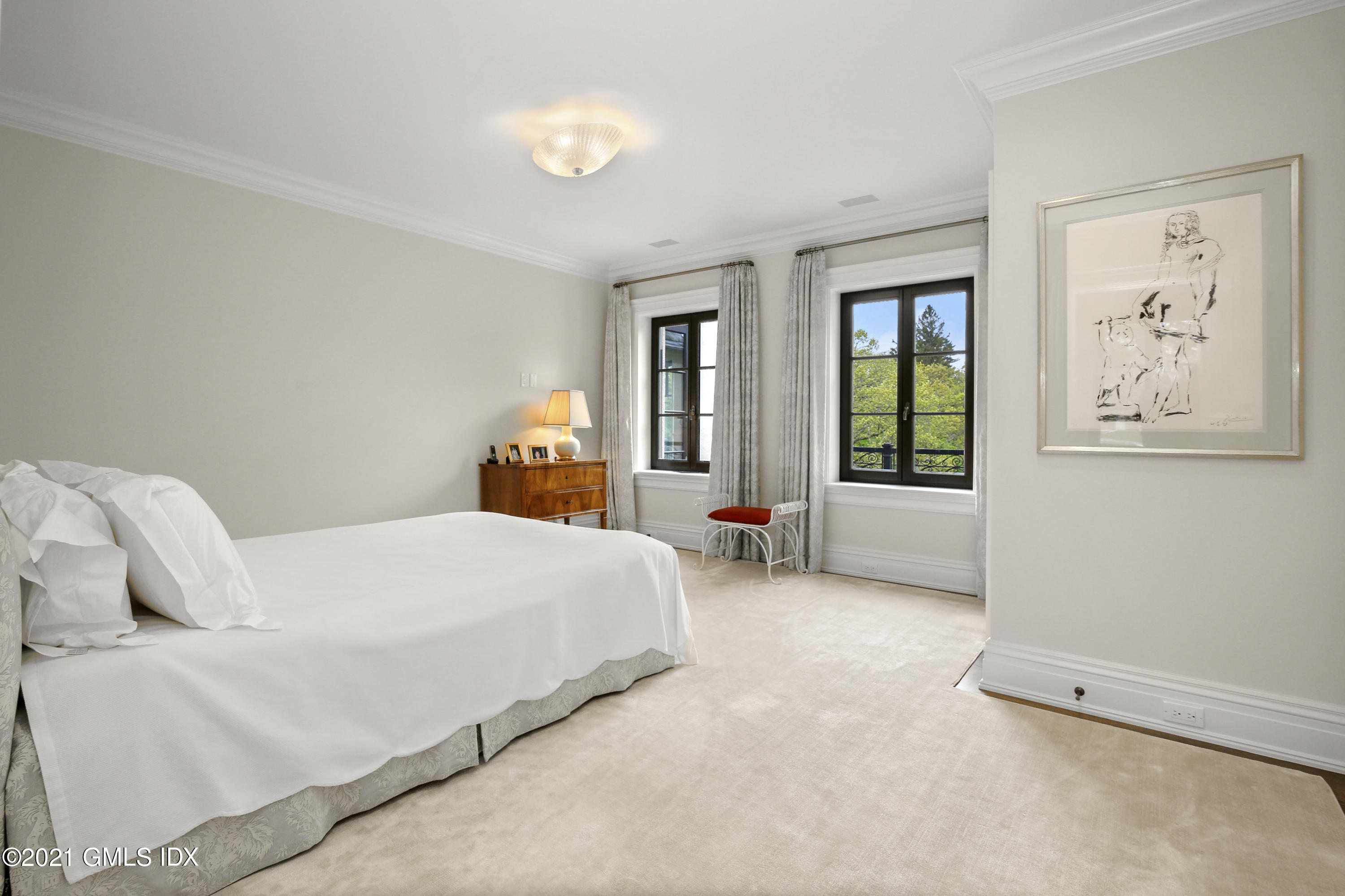 200 Stanwich Road Greenwich, CT 06830 - Photo 51 of 80 a bedroom with a bed painting on wall and a large window