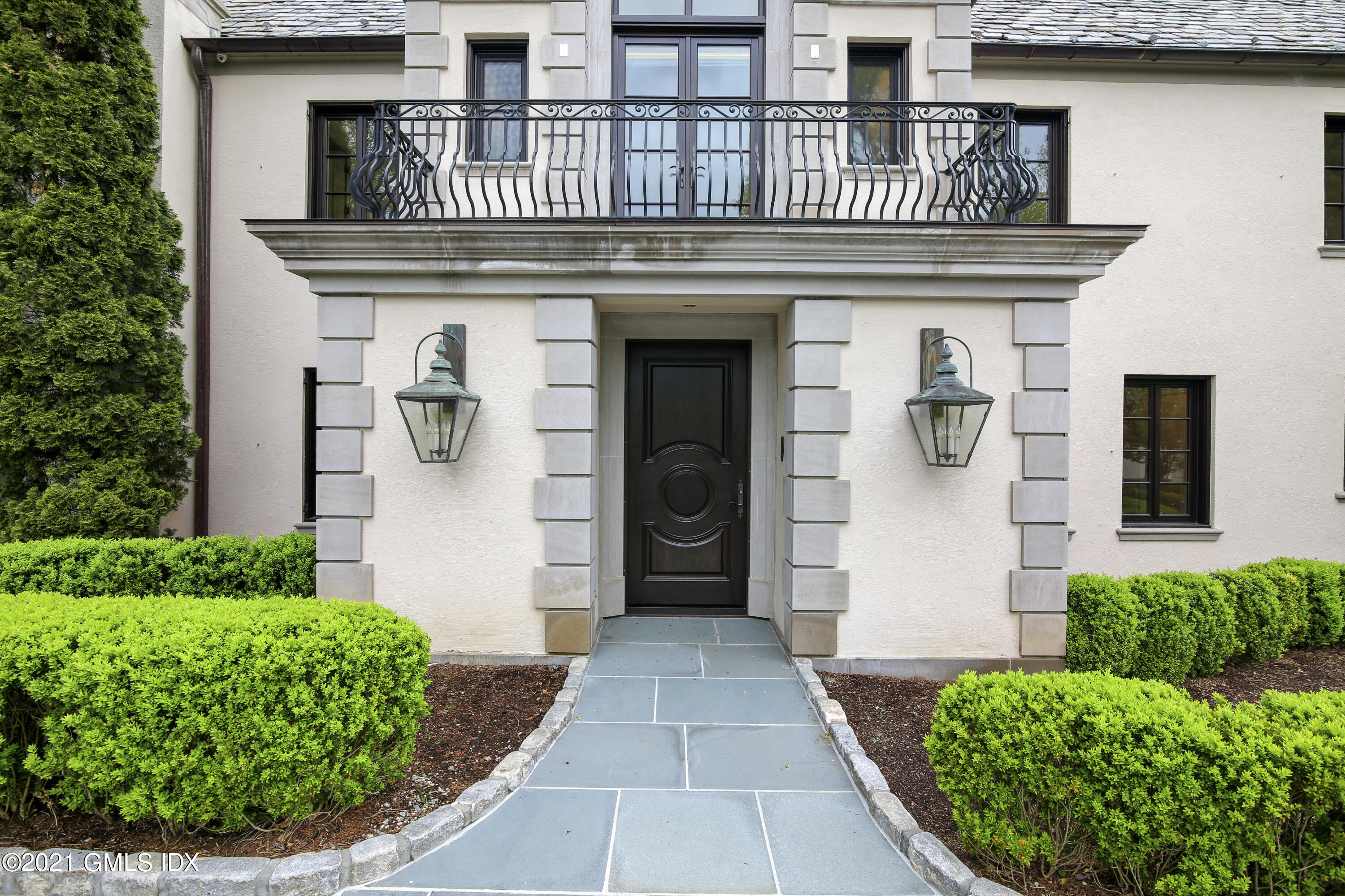 200 Stanwich Road Greenwich, CT 06830 - Photo 10 of 80 a front view of a house with a garden