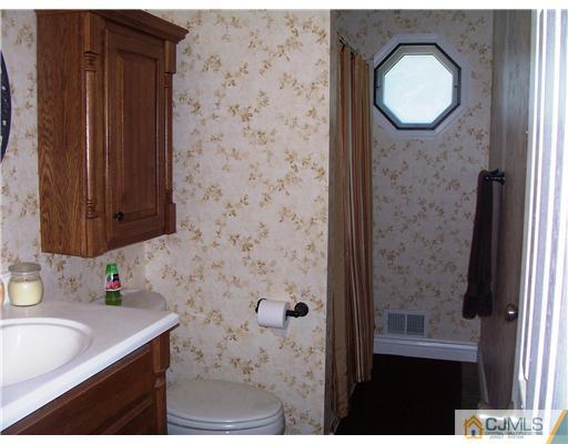 17 Hansen Road Old Bridge, NJ 08857 - Photo 12 of 21 a bathroom with a granite countertop sink a mirror and a shower