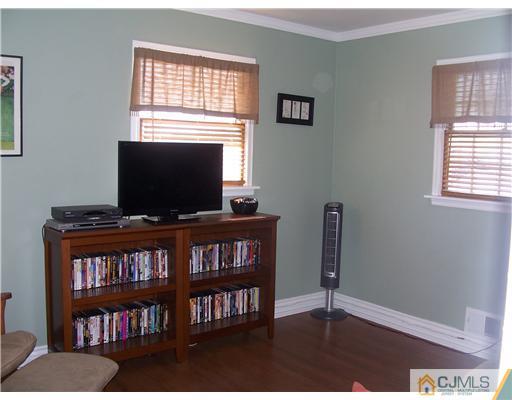 17 Hansen Road Old Bridge, NJ 08857 - Photo 14 of 21 a living room with television and a book shelf