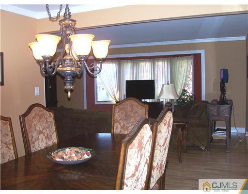 17 Hansen Road Old Bridge, NJ 08857 - Photo 7 of 21 a living room with furniture a chandelier and a window