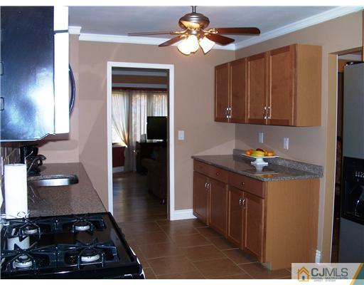 17 Hansen Road Old Bridge, NJ 08857 - Photo 10 of 21 a kitchen with a stove and a refrigerator