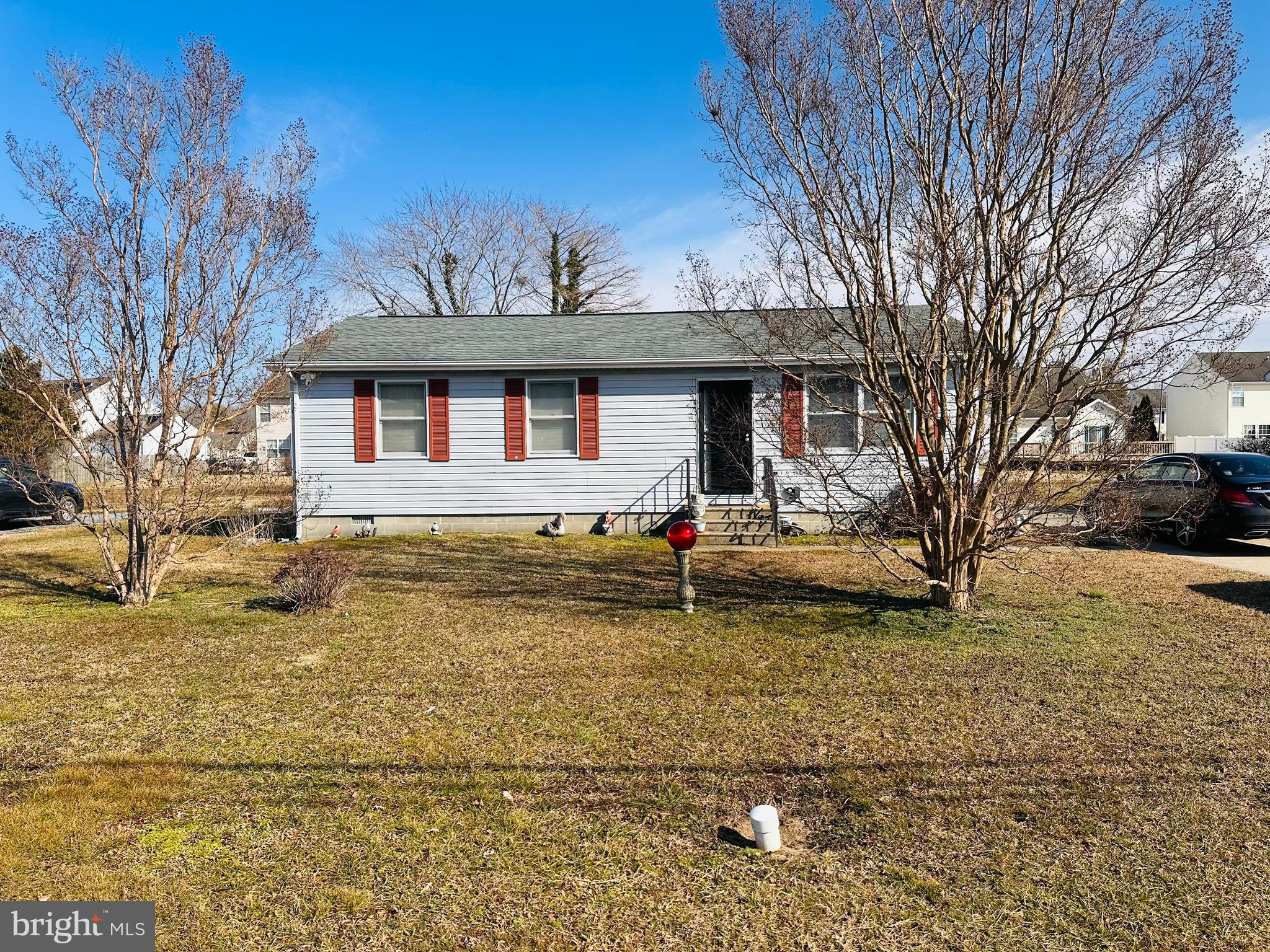 1114 Maces Lane Cambridge, MD 21613 - Photo 1 of 5 a front view of a house with a yard covered with snow