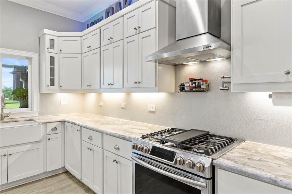 15710 Colding Loop Wimauma, FL 33598 - Photo 12 of 41 a kitchen with white cabinets and appliances