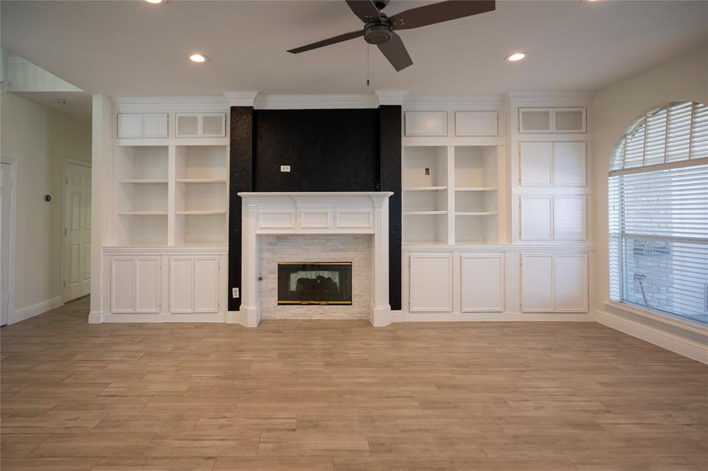 413 Ridge Meade Drive Lewisville, TX 75067 - Photo 15 of 37 large, open living room with built-ins and gas fireplace