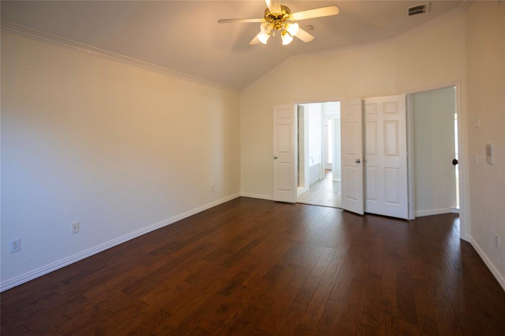 413 Ridge Meade Drive Lewisville, TX 75067 - Photo 19 of 37 Primary bedroom on 2nd floor with wood floors and french door access to master bath