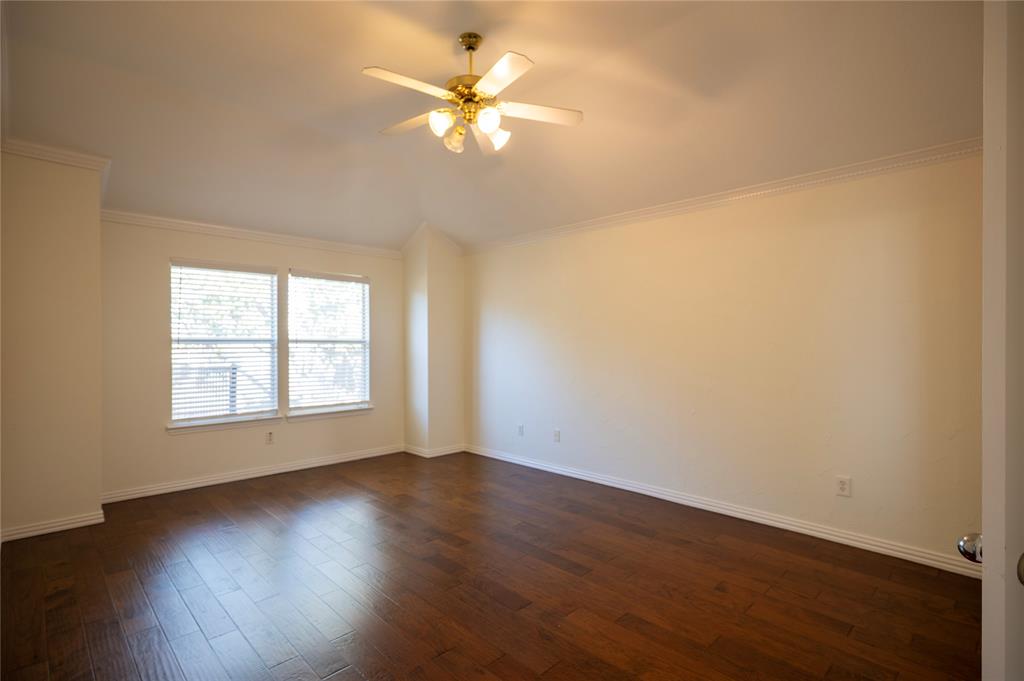 413 Ridge Meade Drive Lewisville, TX 75067 - Photo 20 of 37 Primary bedroom on 2nd floor with wood floors