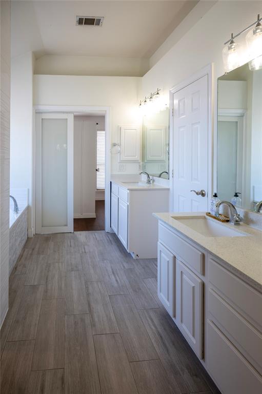 413 Ridge Meade Drive Lewisville, TX 75067 - Photo 22 of 37 Primary bathroom with building in updated shower, jetted tub and 2 sinks