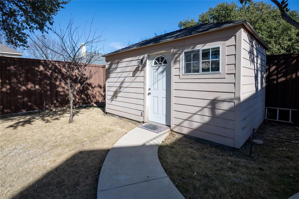 413 Ridge Meade Drive Lewisville, TX 75067 - Photo 33 of 37 Finished Storage shed with concrete flooring with tiles, new paint, window ac unit perfect for storage or gym