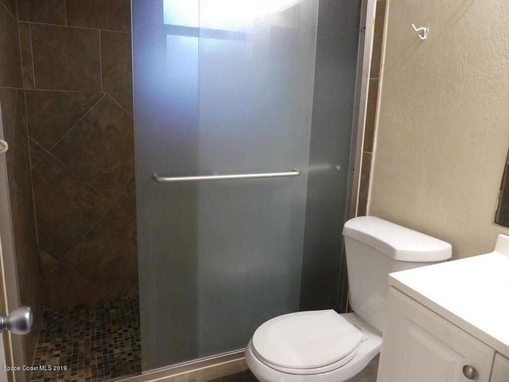 4730 Ivan Street Cocoa, FL 32927 - Photo 11 of 23 a white toilet sitting next to a shower