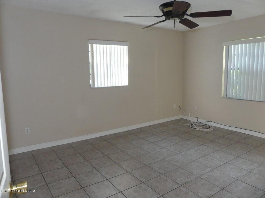 4730 Ivan Street Cocoa, FL 32927 - Photo 12 of 23 an empty room with windows and fan