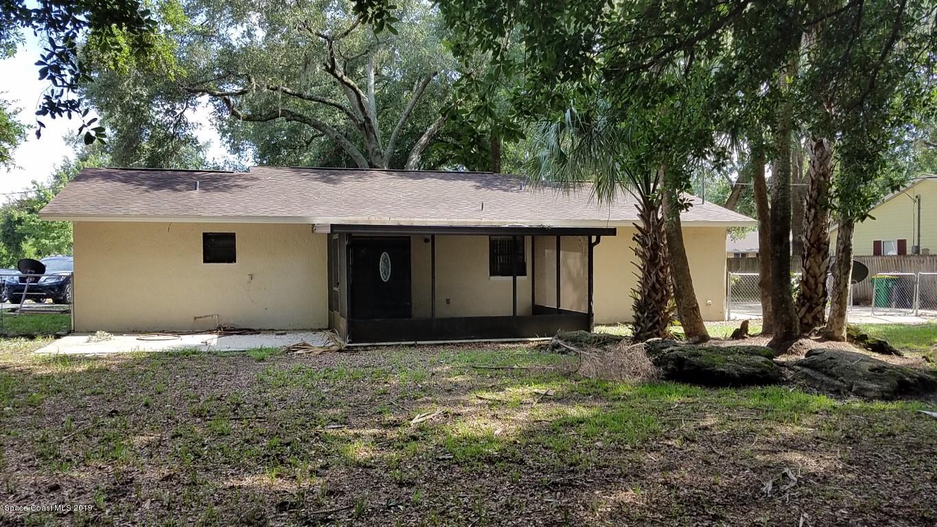 4730 Ivan Street Cocoa, FL 32927 - Photo 15 of 23 a view of a house with backyard and trees
