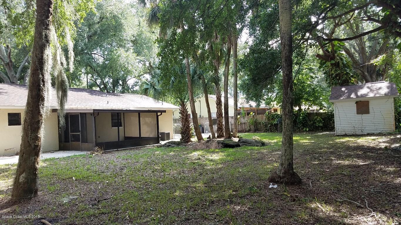 4730 Ivan Street Cocoa, FL 32927 - Photo 16 of 23 a backyard of a house with lots of green space