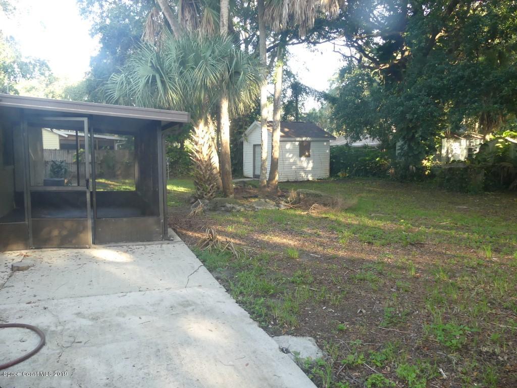 4730 Ivan Street Cocoa, FL 32927 - Photo 18 of 23 a view of a yard hardwood and floor to ceiling window