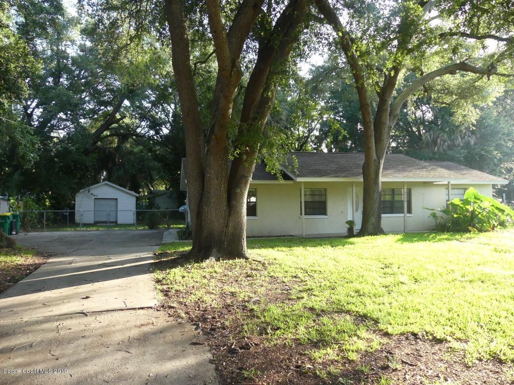 4730 Ivan Street Cocoa, FL 32927 - Photo 21 of 23 a front view of a house with a yard and garage