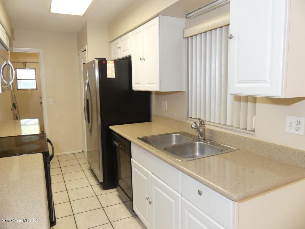4730 Ivan Street Cocoa, FL 32927 - Photo 6 of 23 a kitchen with granite countertop a sink stove and cabinets